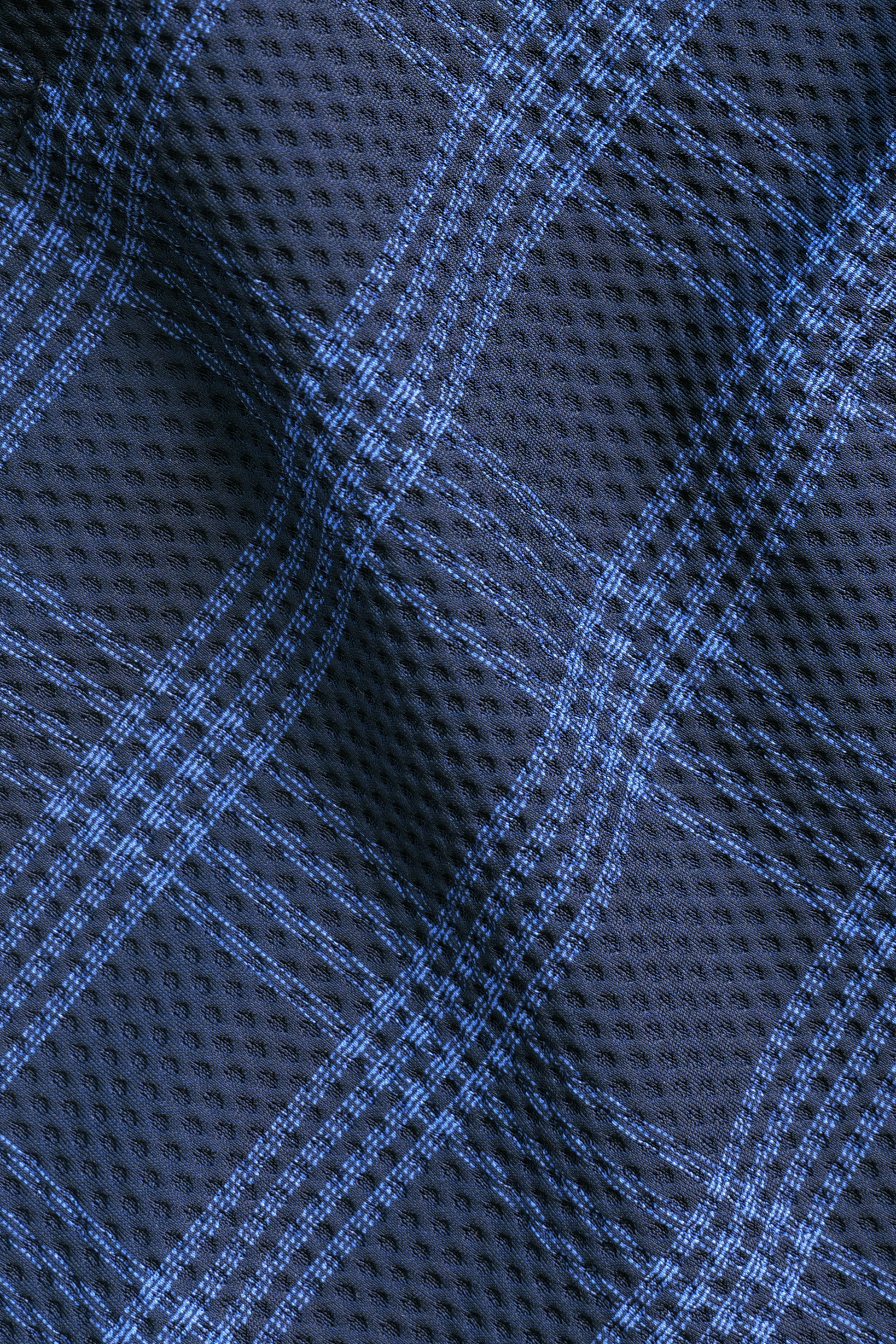Close-up of Twillory's AIR Blazer // Navy Blue Plaid, featuring a textured 360° Airflow Fabric with a black base and blue plaid pattern. The mesh-like, perforated surface creates large squares for a sporty, modern look.