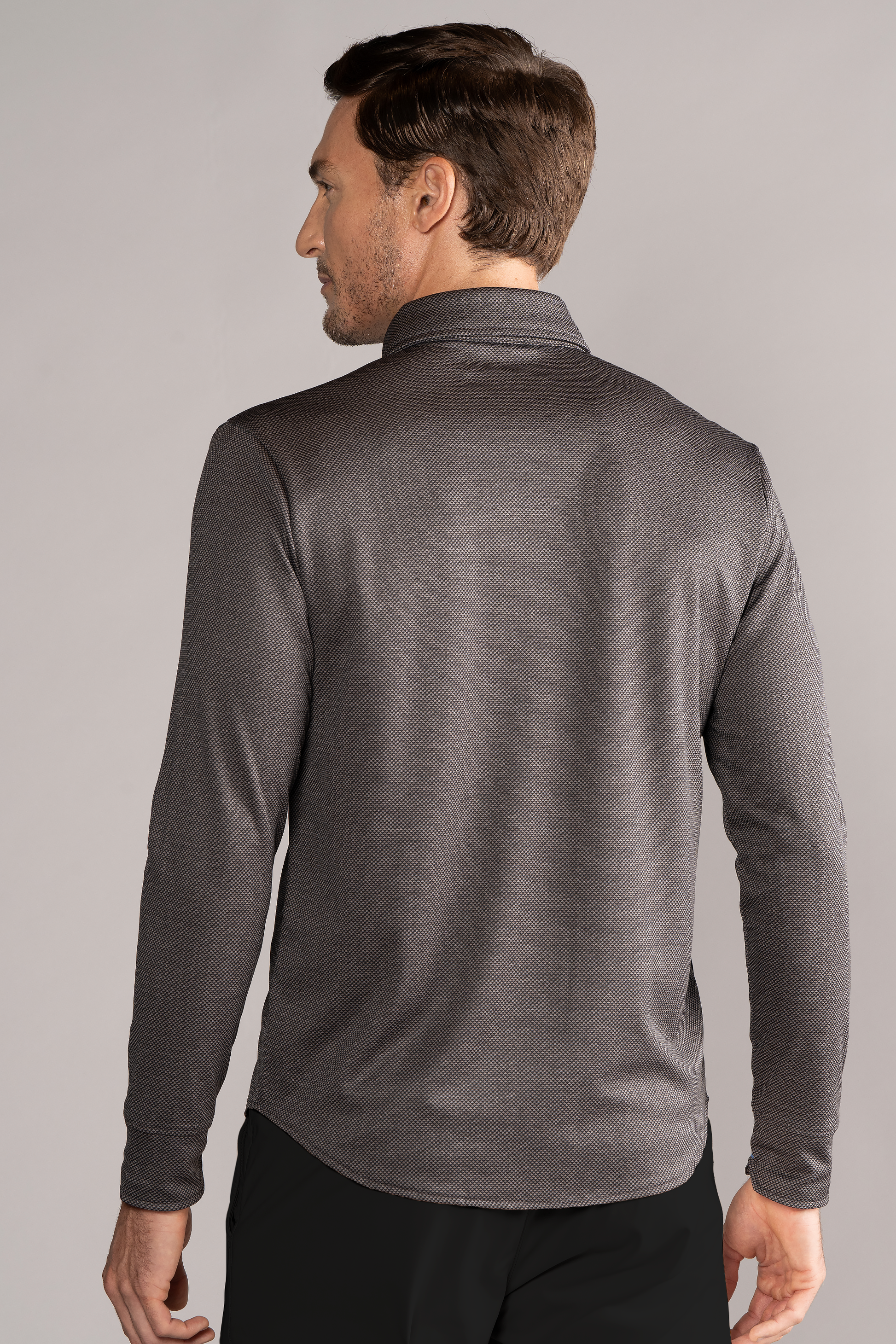 A man in a Twillory Long Sleeve Button Down Polo Dot in Grey Scale.