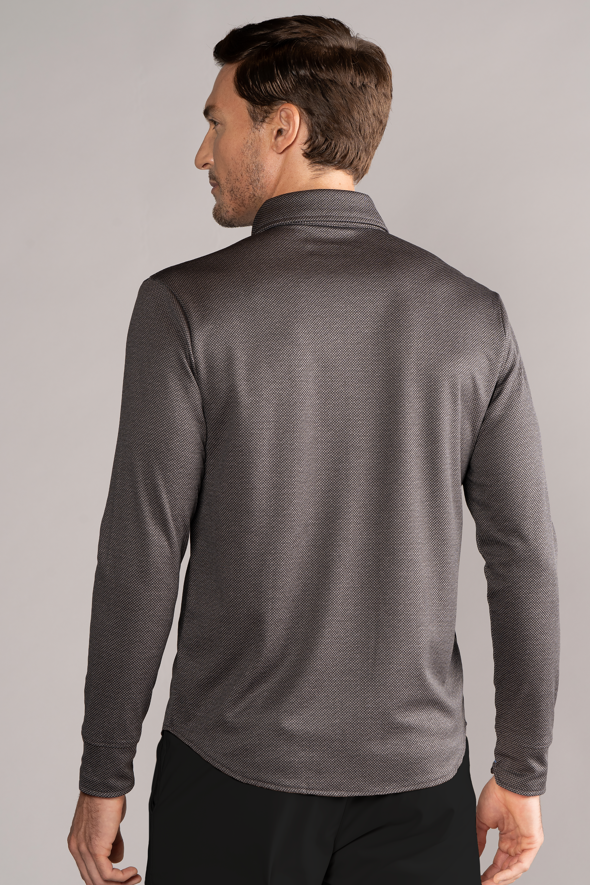 A man in a Twillory Long Sleeve Button Down Polo Dot in Grey Scale.