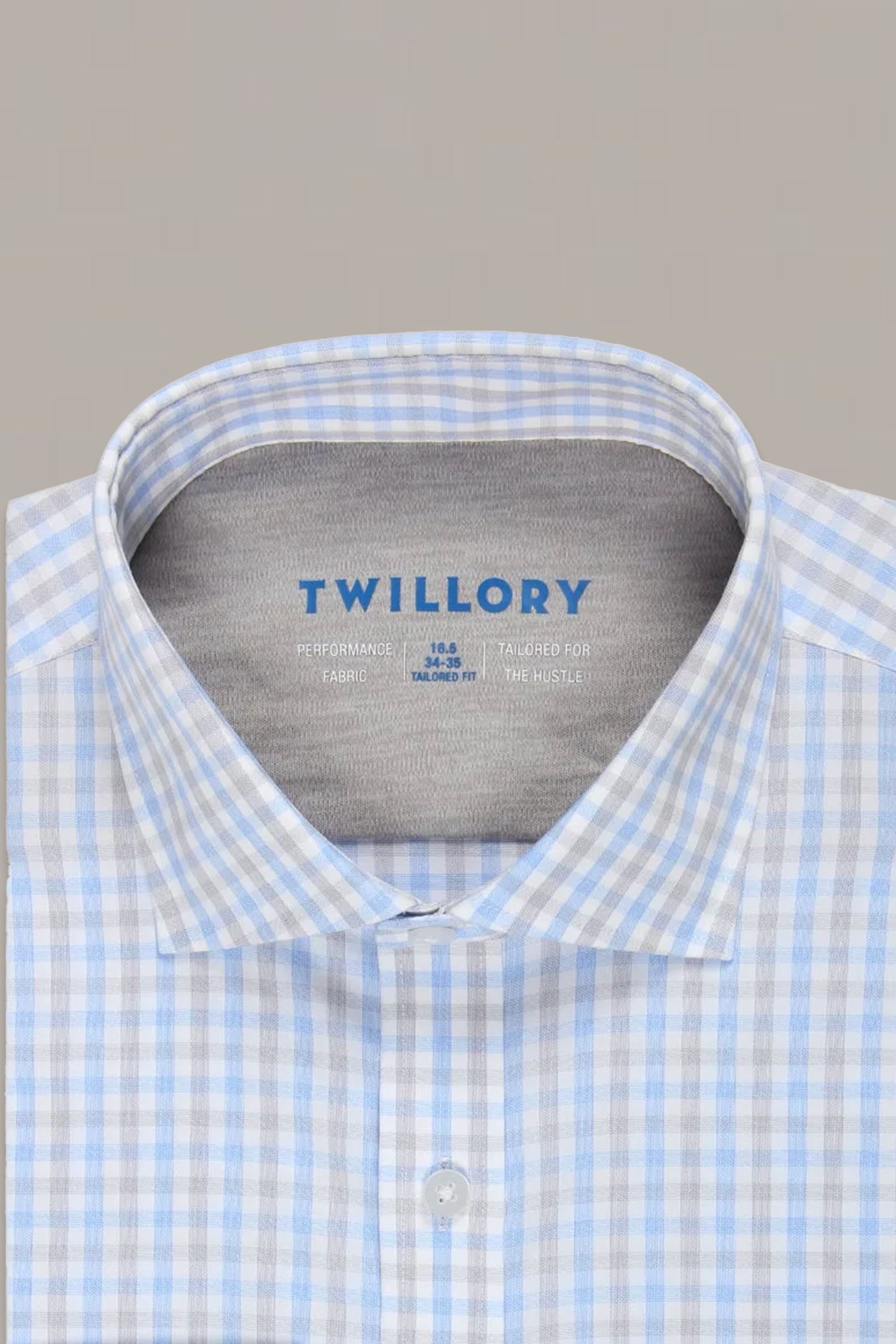 A close-up of the Twillory Leader Check // Grey Blue Tattersall Performance Shirt, featuring a classic spread collar and 4-way stretch fabric in a blue and grey check pattern. The shirt is shown against a plain gray background.