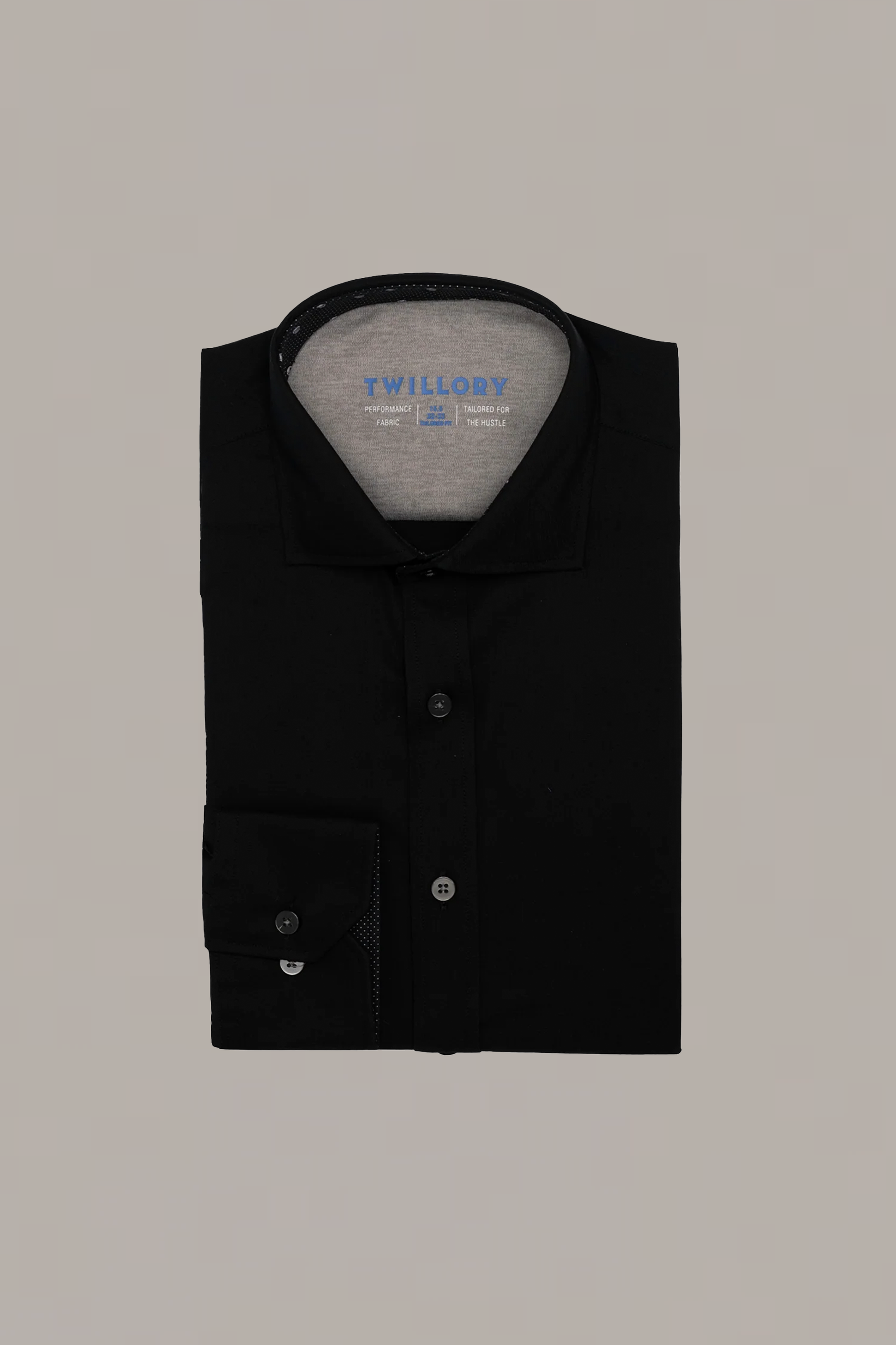 A neatly folded Leader Contrast // Black Skull shirt by Twillory, with visible collar and cuff. “Twillory” is printed in blue inside the collar. This Non-Iron dress shirt is shown on a plain, light gray background.