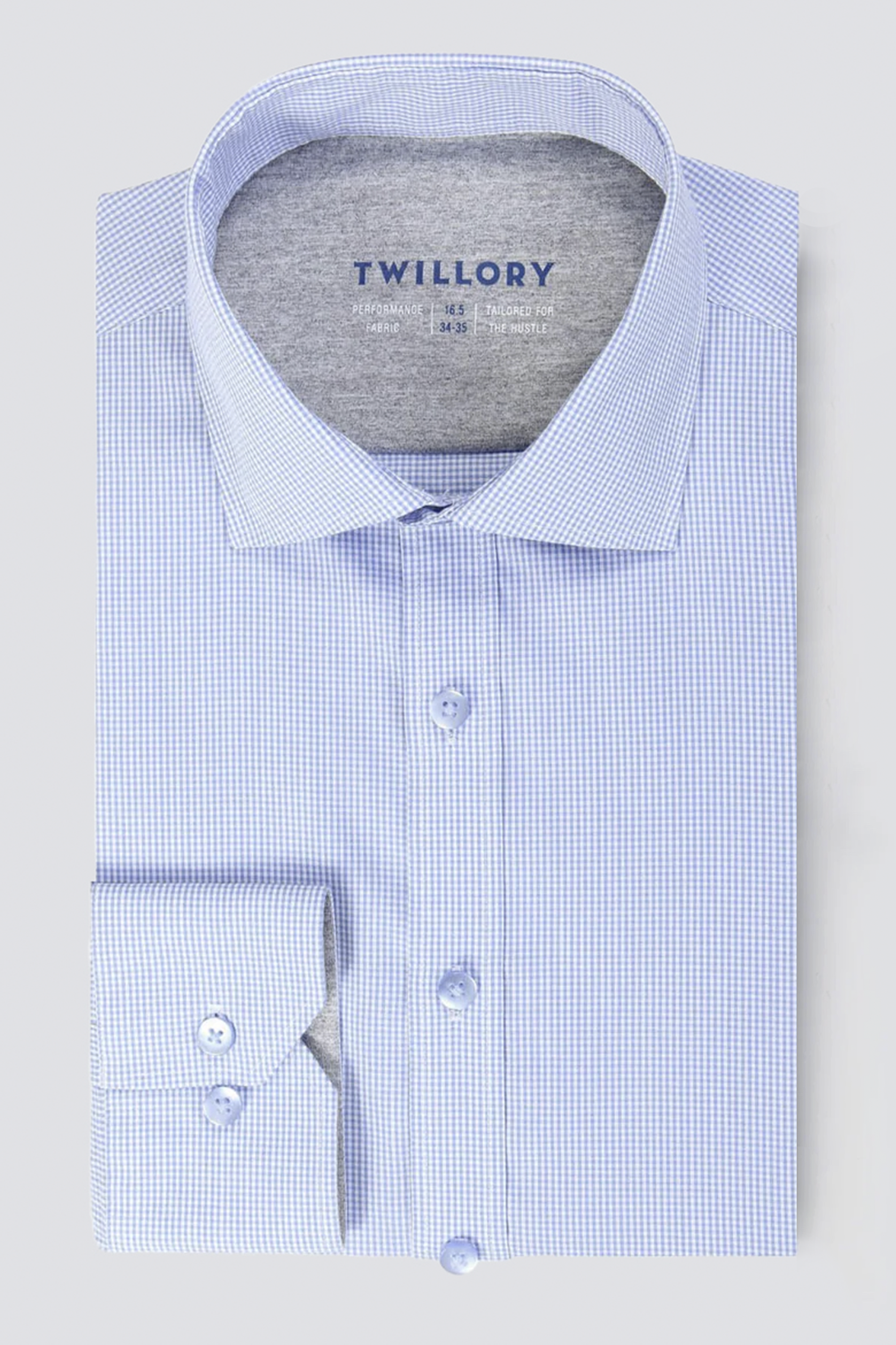 The Twillory Leader Houndstooth // Micro Blue men’s dress shirt features a light blue and white check pattern, spread collar, buttoned cuff, “Twillory” in blue inside the collar, and smooth 4-Way Stretch fabric for comfort.