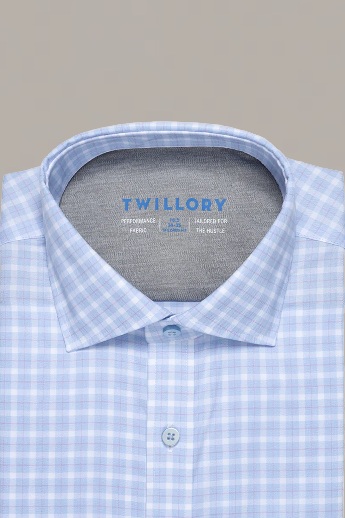 The Leader Plaid // Sky Blue by Twillory is a light blue and white performance shirt with a spread collar, branded collar interior, light blue buttons, and comfortable 4-way Stretch fabric, displayed against a plain background.
