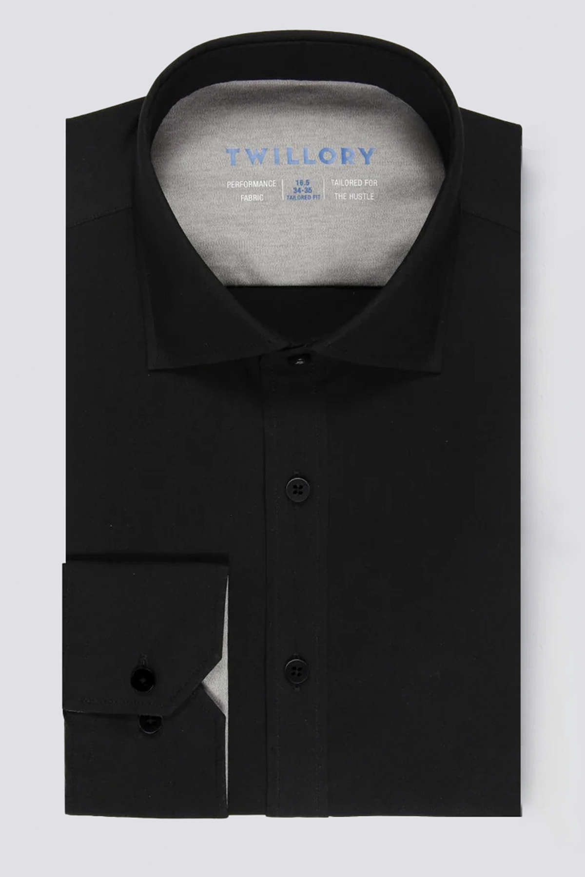 The Twillory Leader Solid // Black is a sleek black stretch dress shirt with a pointed collar and black buttons, shown on a light gray background. It features a gray inner collar and the “Twillory” label for modern comfort and style.
