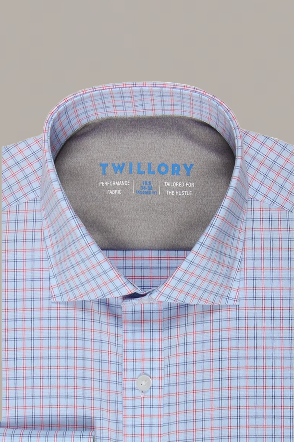 A close-up of the Twillory Leader Windowpane // Red Blue men’s dress shirt shows its blue and red checkered pattern, buttoned collar, and inner label featuring “Performance Fabric” and “4-way stretch”—tailored for the hustle.