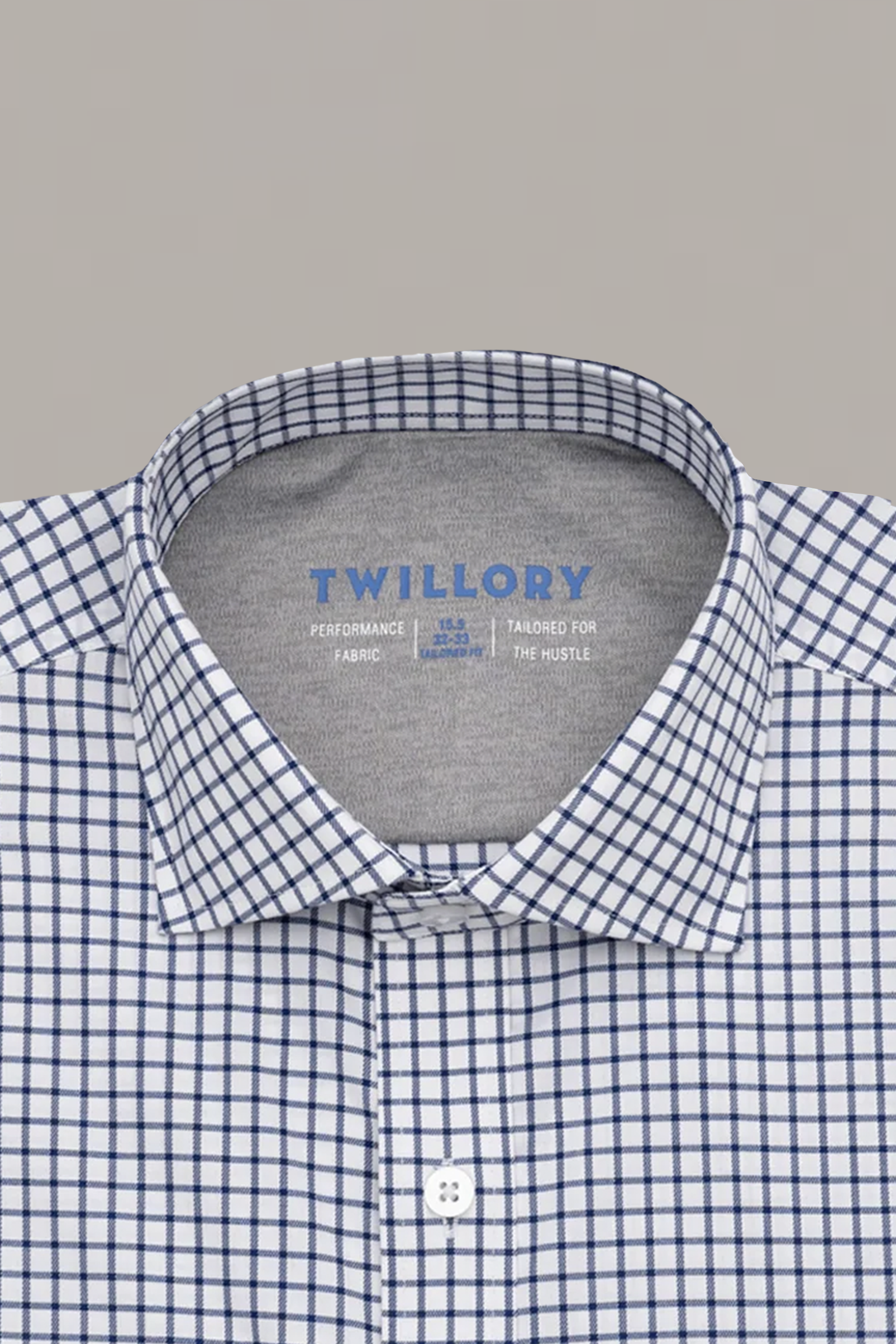 A close-up of the Twillory Leader Windowpane // Navy shirt, featuring a white base with a navy blue grid pattern, collared button-up style, and "TWILLORY" label inside the collar. Set against a plain light gray background.