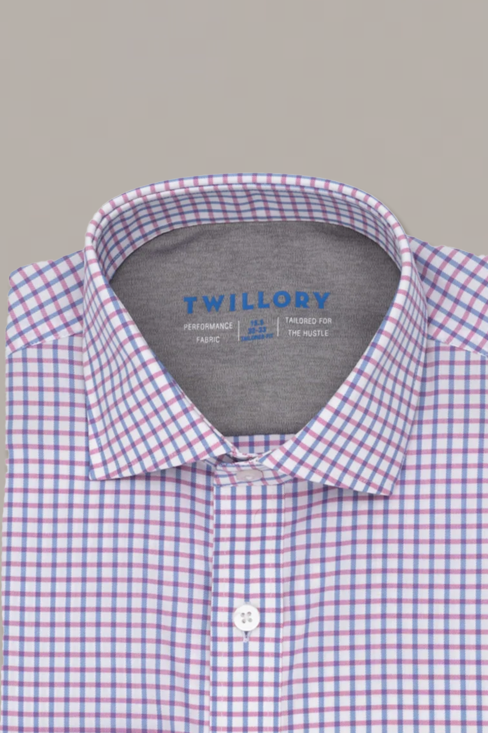 The Twillory Leader Windowpane // Pink Blue shirt features a white base with blue and pink grid checks, a gray inner collar lining, and easy care instructions—combining comfort and subtle style against a light gray background.