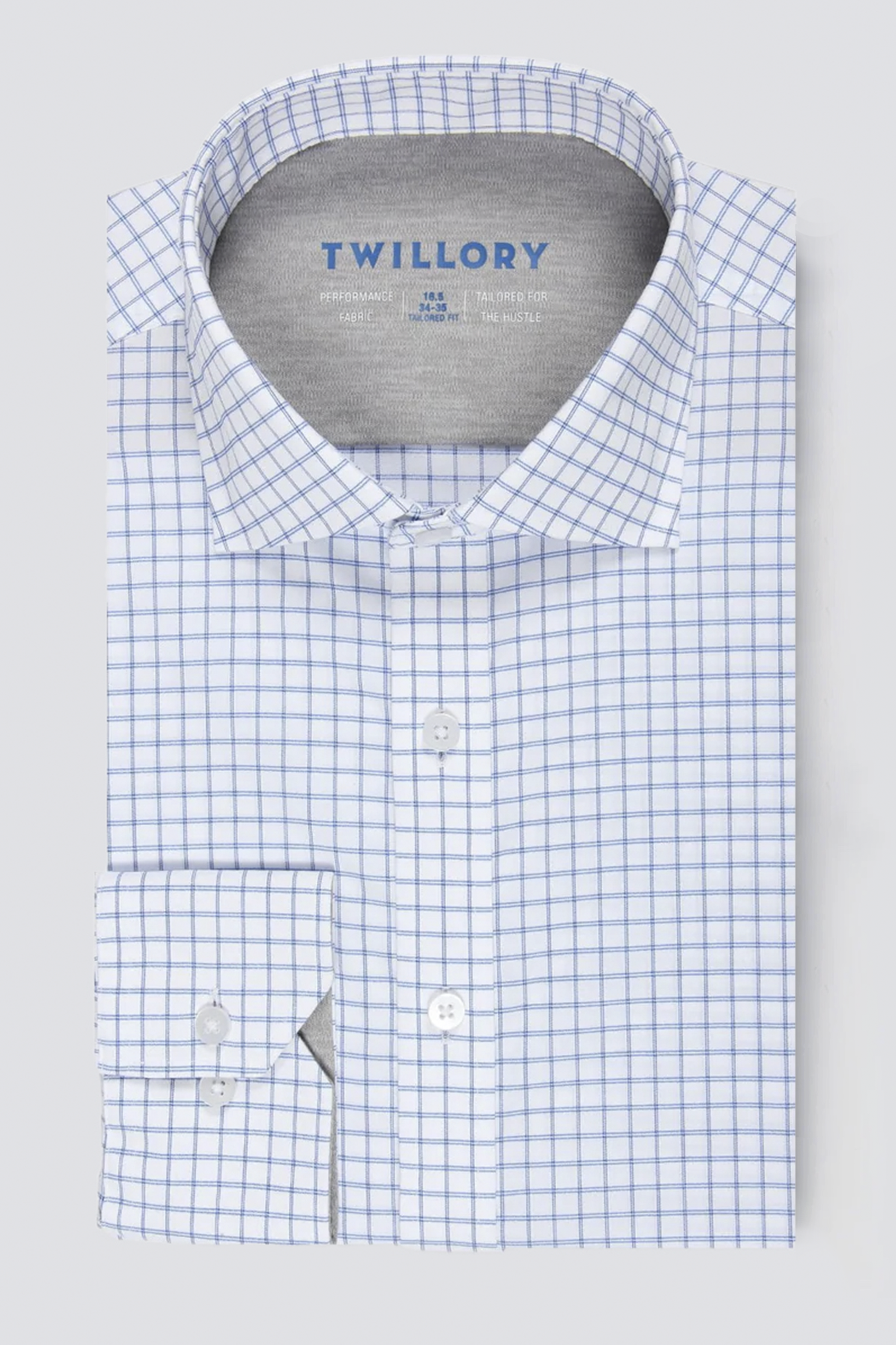 The Twillory Leader Windowpane // Blue is a neatly folded, long-sleeve performance shirt with a white base and blue grid pattern, classic collar, 4-way stretch, white buttons, and an inner “Twillory” brand label.