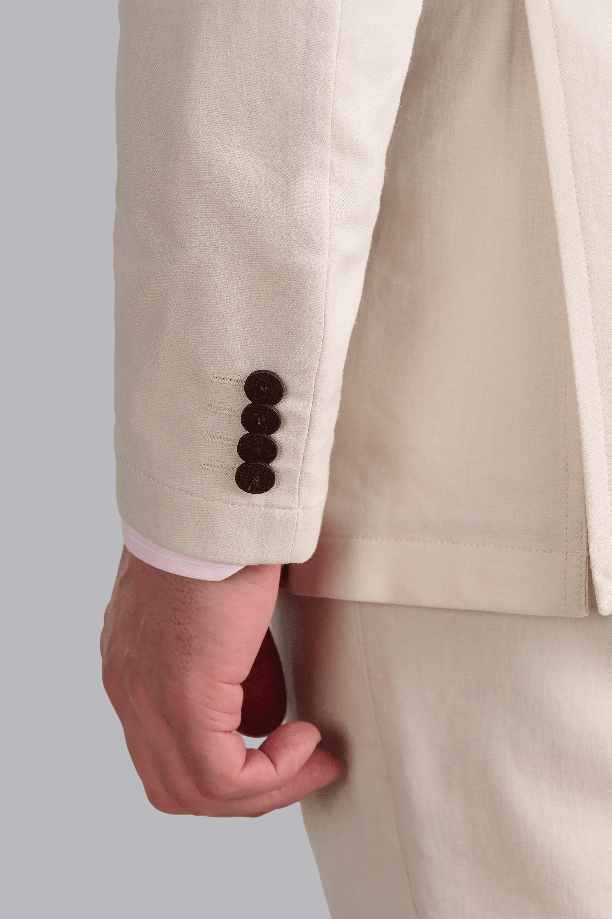 Close-up of the cuff on a Twillory Bone Performance Linen Jacket, showing the textured linen weave and reinforced button stitching. This wrinkle-resistant fabric combines the aesthetic of traditional linen with performance technology for all-day professional wear.