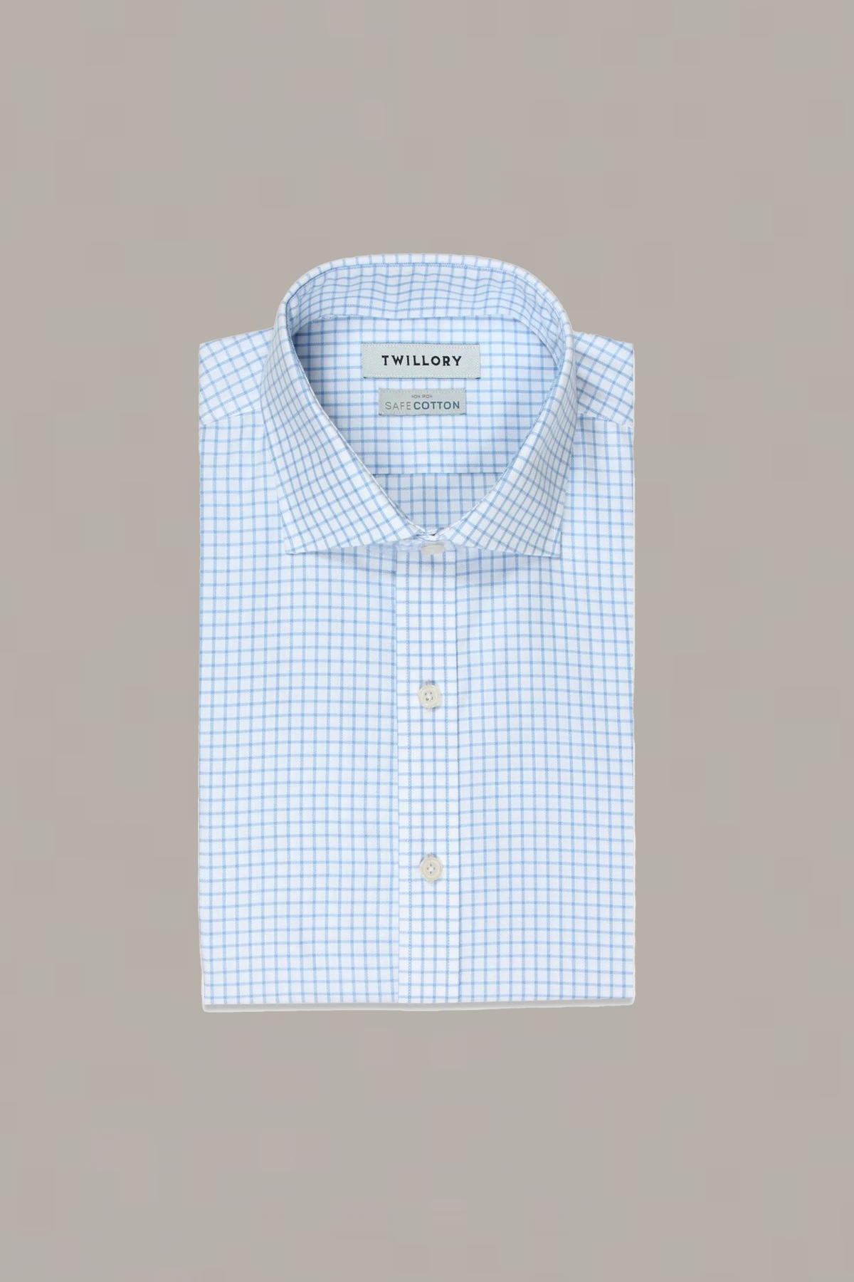 A neatly folded Twillory Non-Iron Sky Windowpane shirt with long sleeves, a light blue and white checkered pattern, stiff collar, white buttons, and visible label inside the collar, set against a plain light gray background.