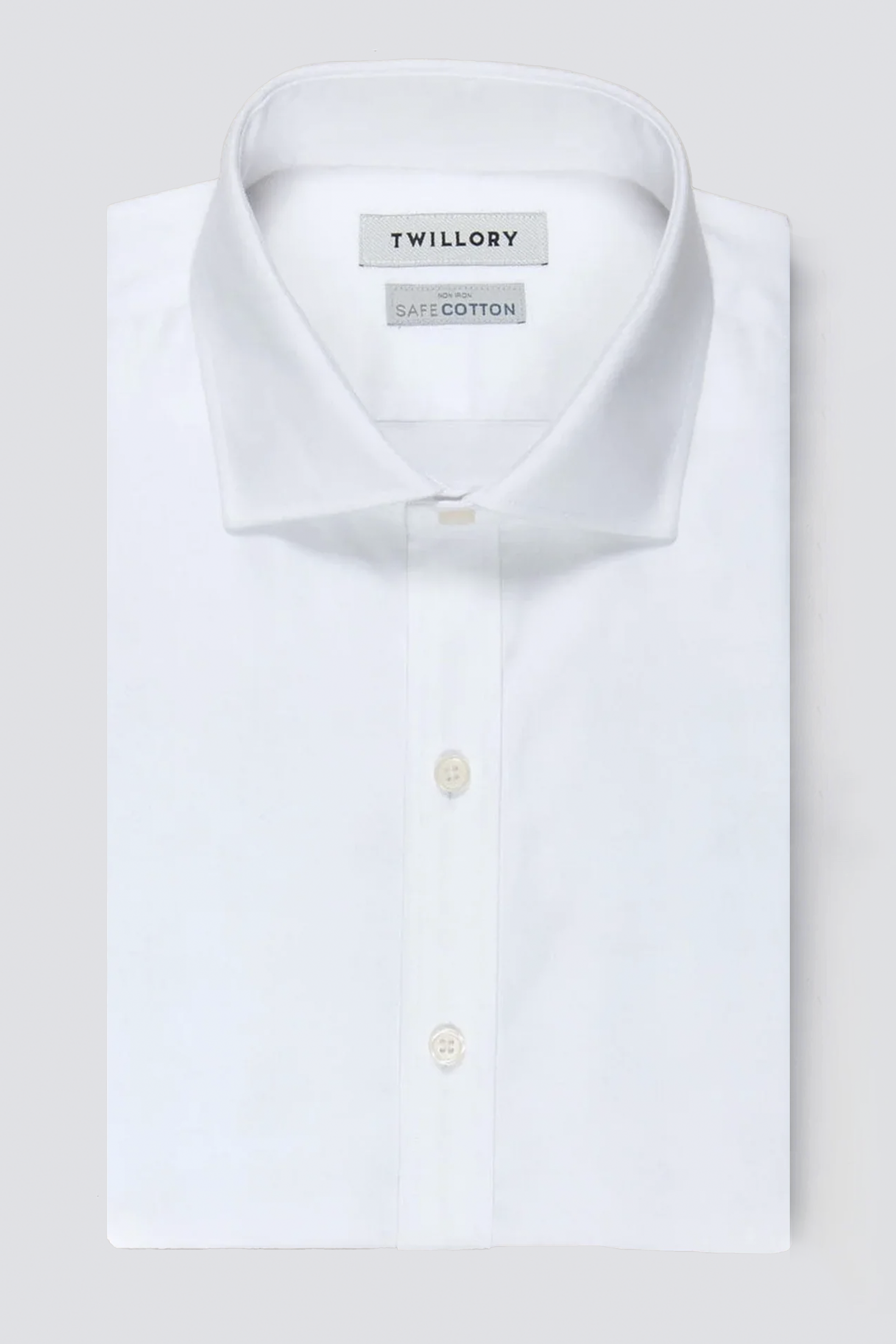The Twillory Non-Iron White Twill shirt, made from SafeCotton fabric, features a classic collar and white buttons, with visible Twillory and SafeCotton labels inside. Displayed neatly folded against a light gray background.