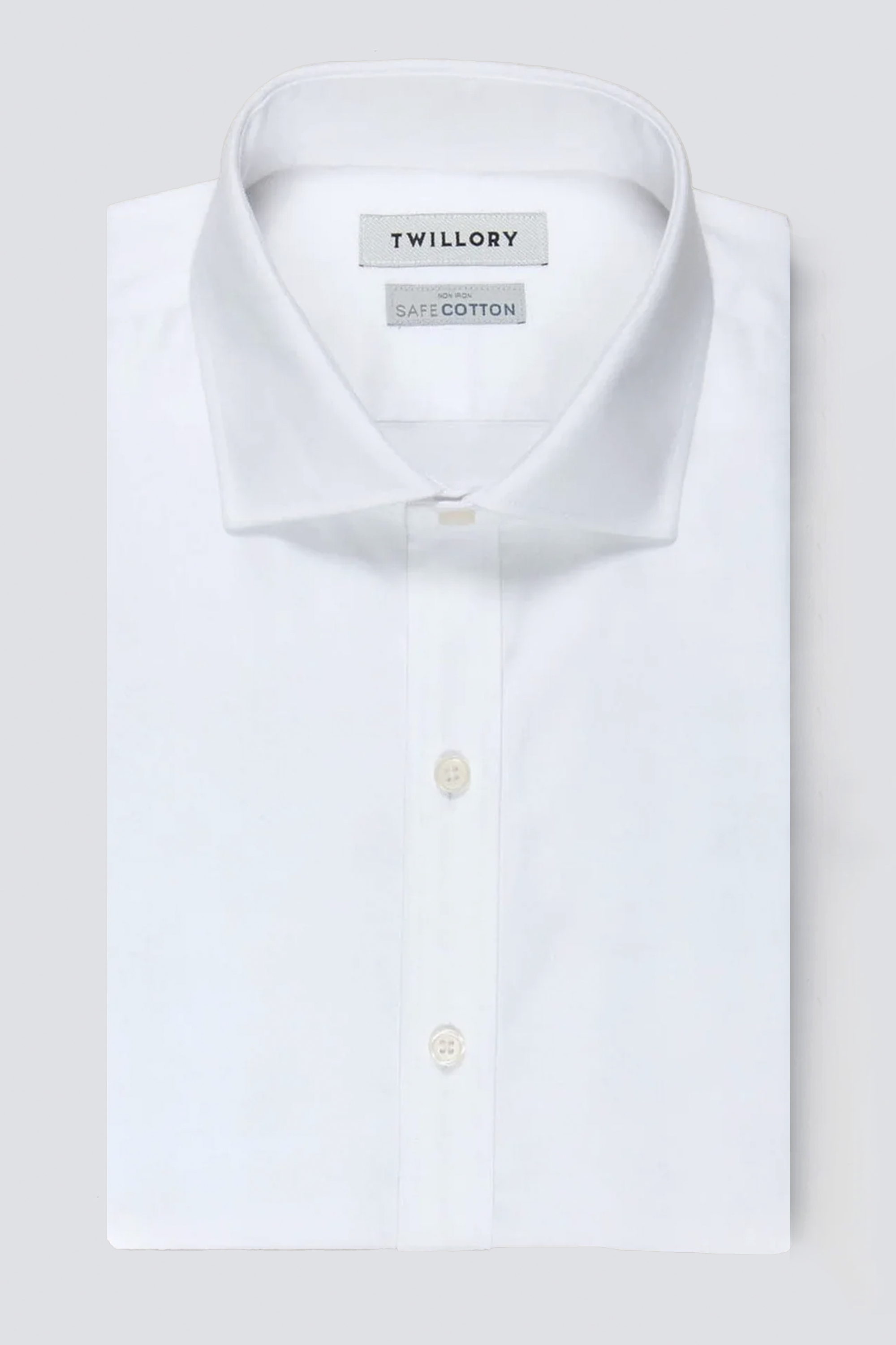 The Twillory Non-Iron White Twill shirt, made from SafeCotton fabric, features a classic collar and white buttons, with visible Twillory and SafeCotton labels inside. Displayed neatly folded against a light gray background.