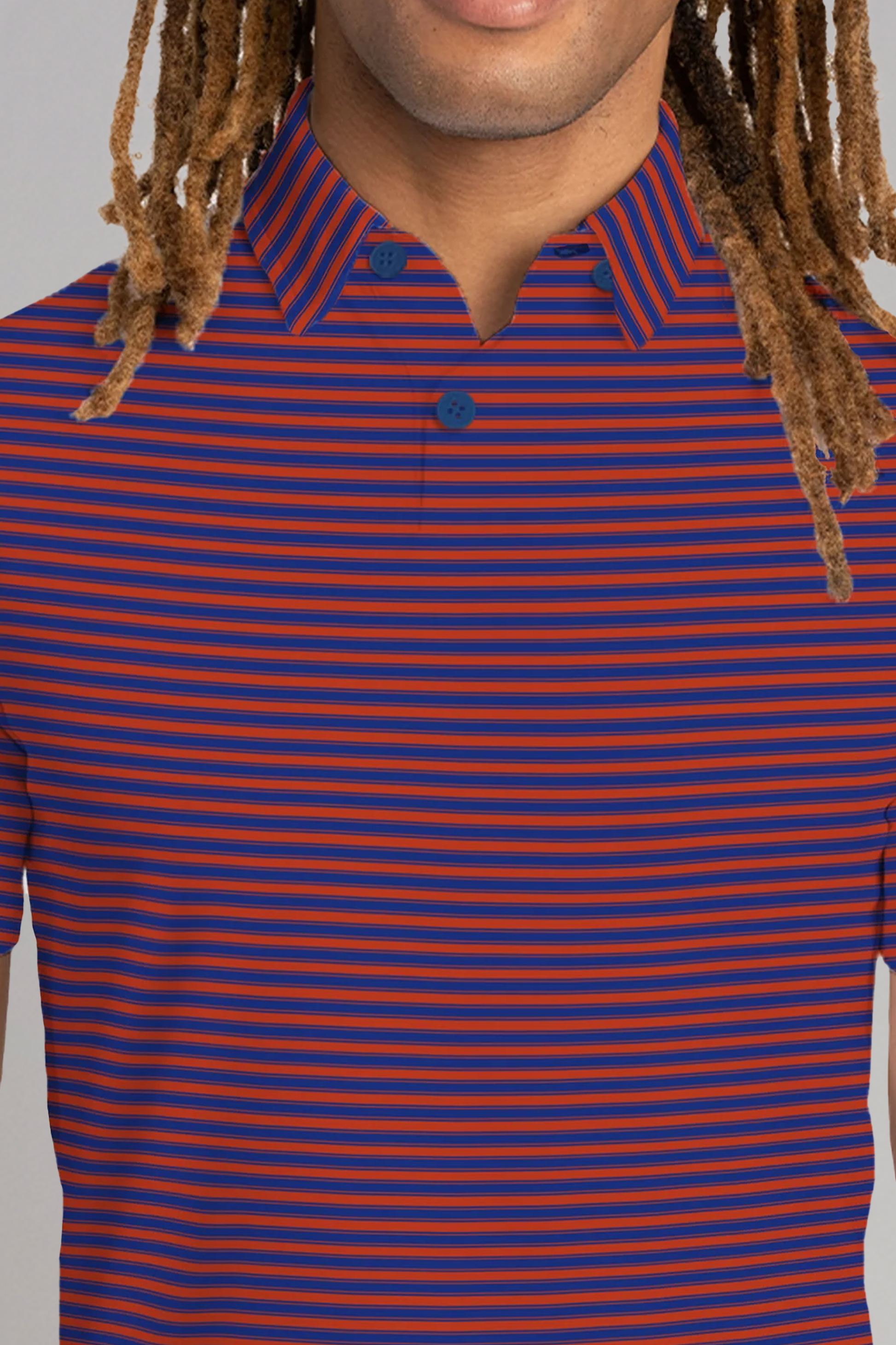 A person with light brown skin and long dreadlocks wears the Twillory Short Sleeve Polo Stripe // Red Blue. Only their lower face and upper torso are shown, highlighting the shirt’s cooling tech fabric for all-day comfort. The person is not smiling.