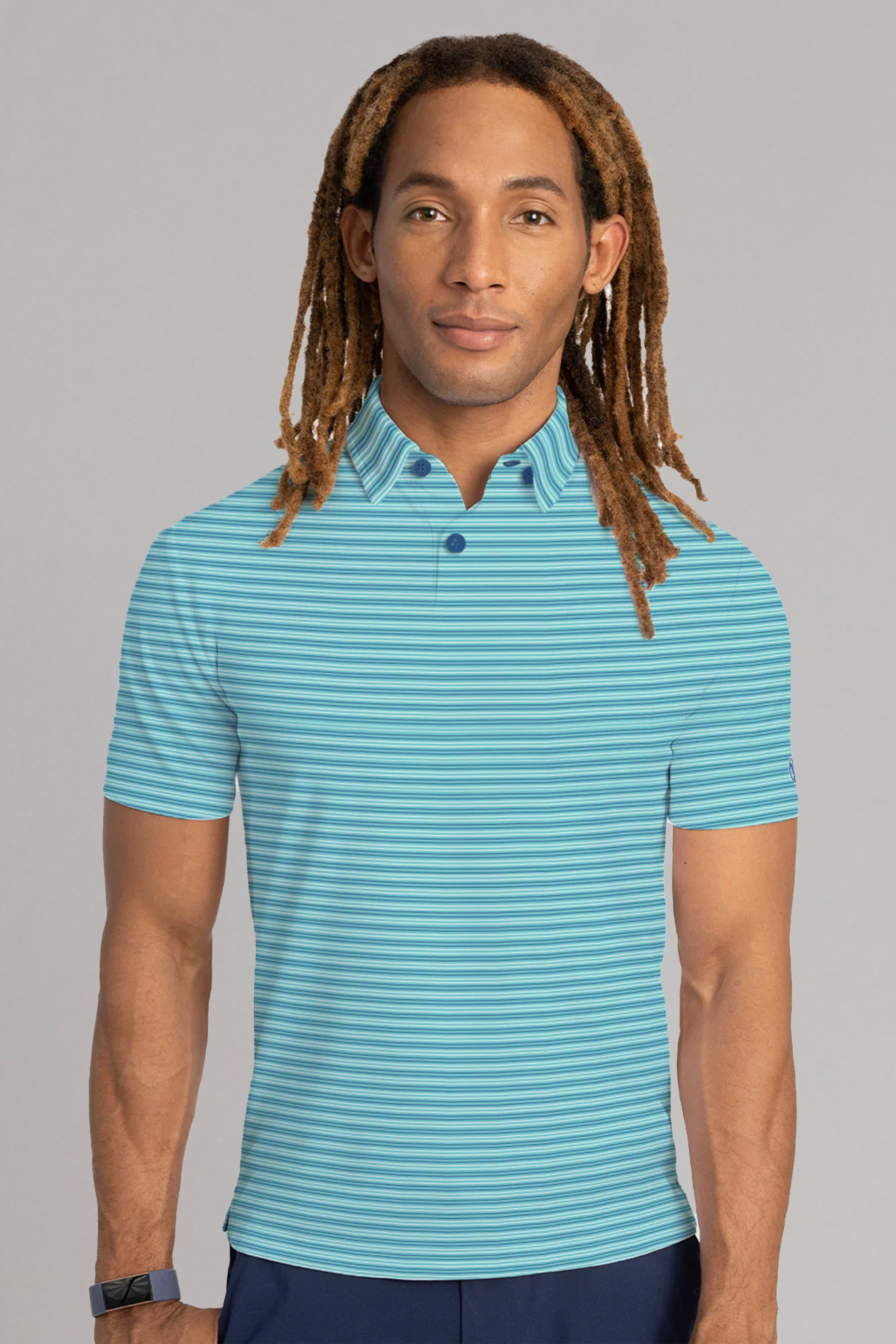 A person with long, light brown dreadlocks wears a Twillory Short Sleeve Polo Stripe in Teal Aqua, standing forward against a plain gray background with a neutral expression and a black wristband on their left wrist.