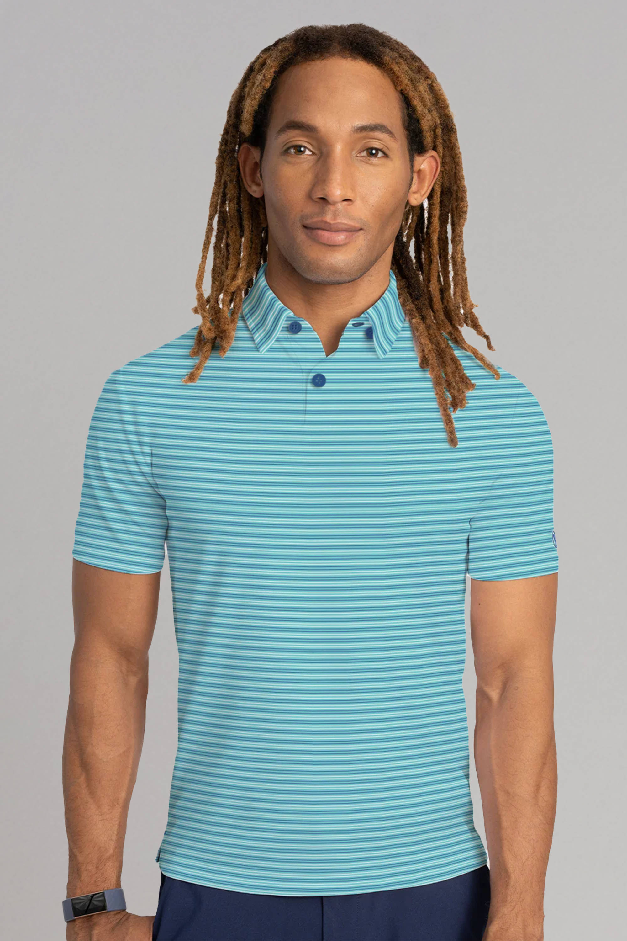 A person with long, light brown dreadlocks wears a Twillory Short Sleeve Polo Stripe in Teal Aqua, standing forward against a plain gray background with a neutral expression and a black wristband on their left wrist.