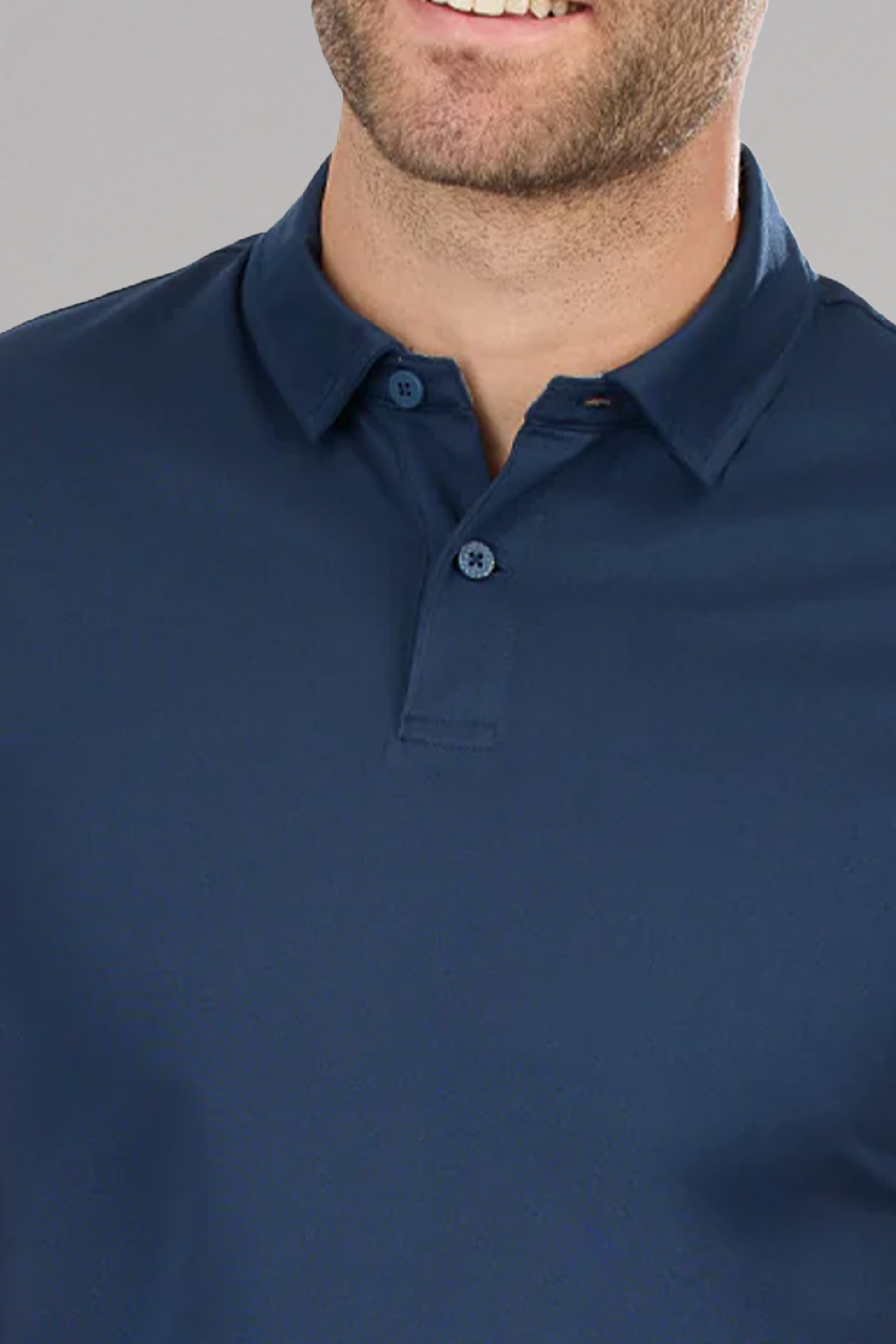A man wears the Twillory Slim Fit Pique Polo Solid in navy, partially unbuttoned. Only his mouth and part of his beard are visible against a plain gray background.