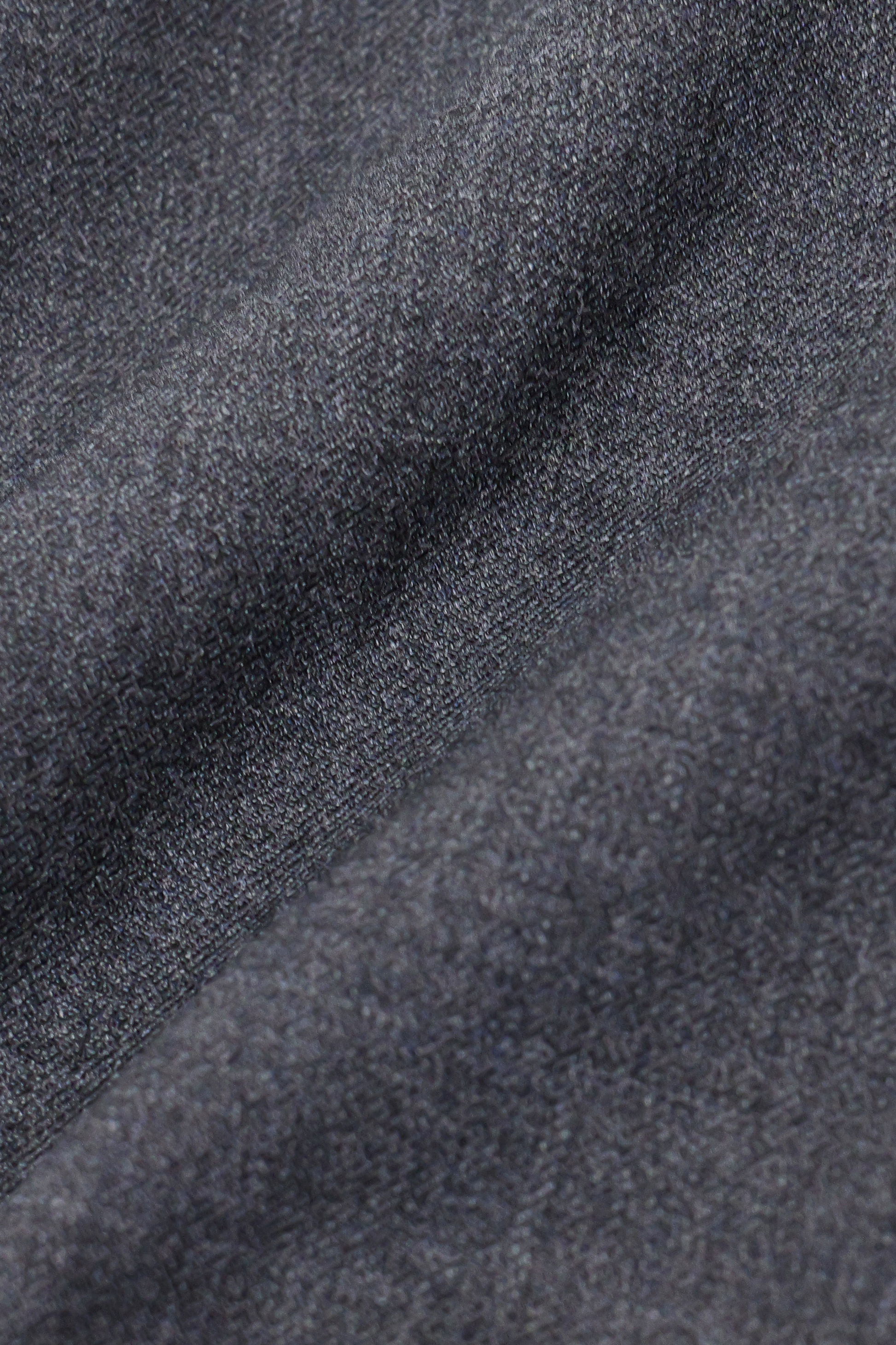 Close-up of Twillory’s Hybrid Wool Pants in Grey Heather, featuring soft, dark gray fabric with subtle ridges and a matte, brushed look. The 4-way stretch material ensures comfort and is ideal for cozy clothing.