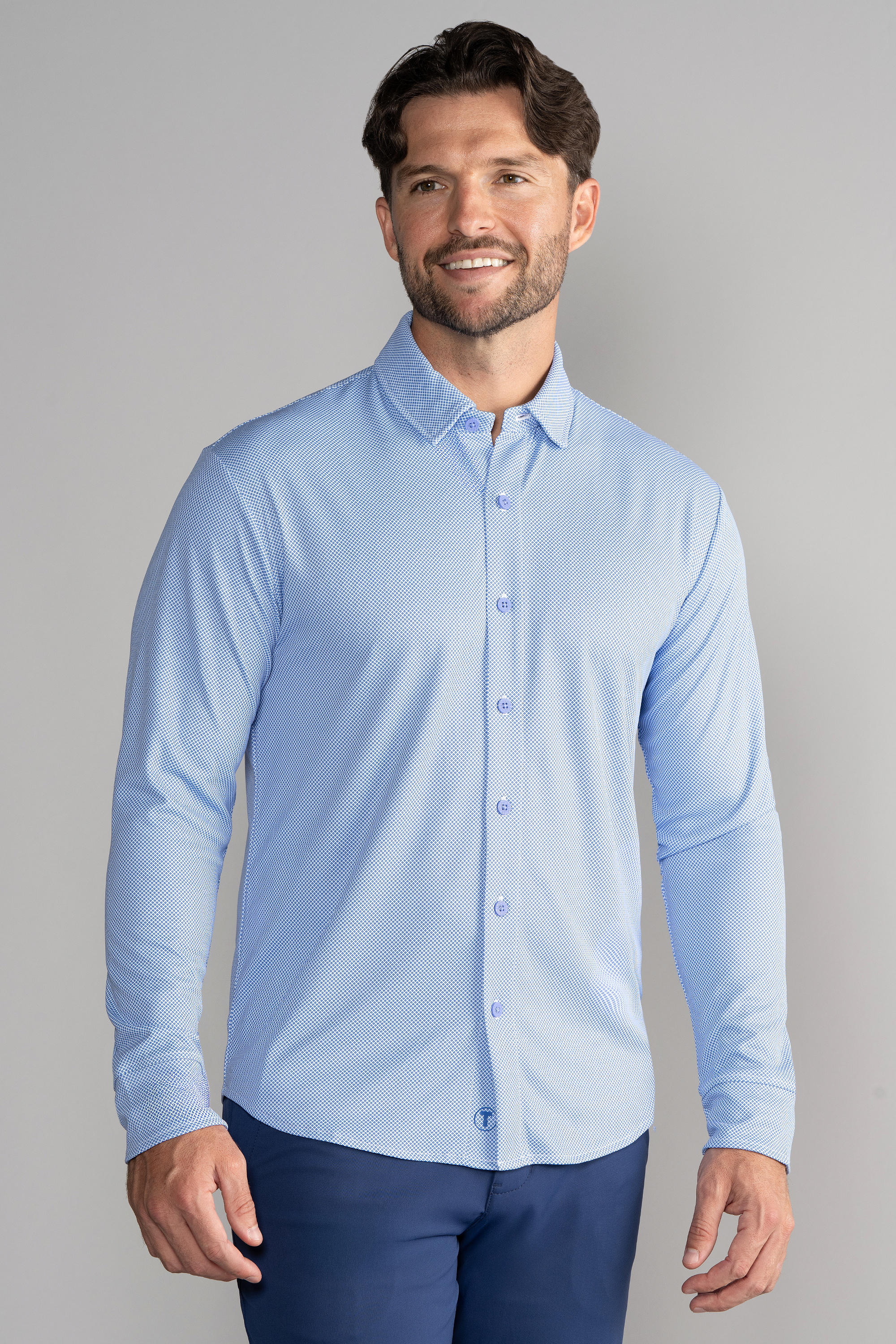 A man wearing a Twillory Long Sleeve Button Down Polo Dot shirt in Blue Diamond.