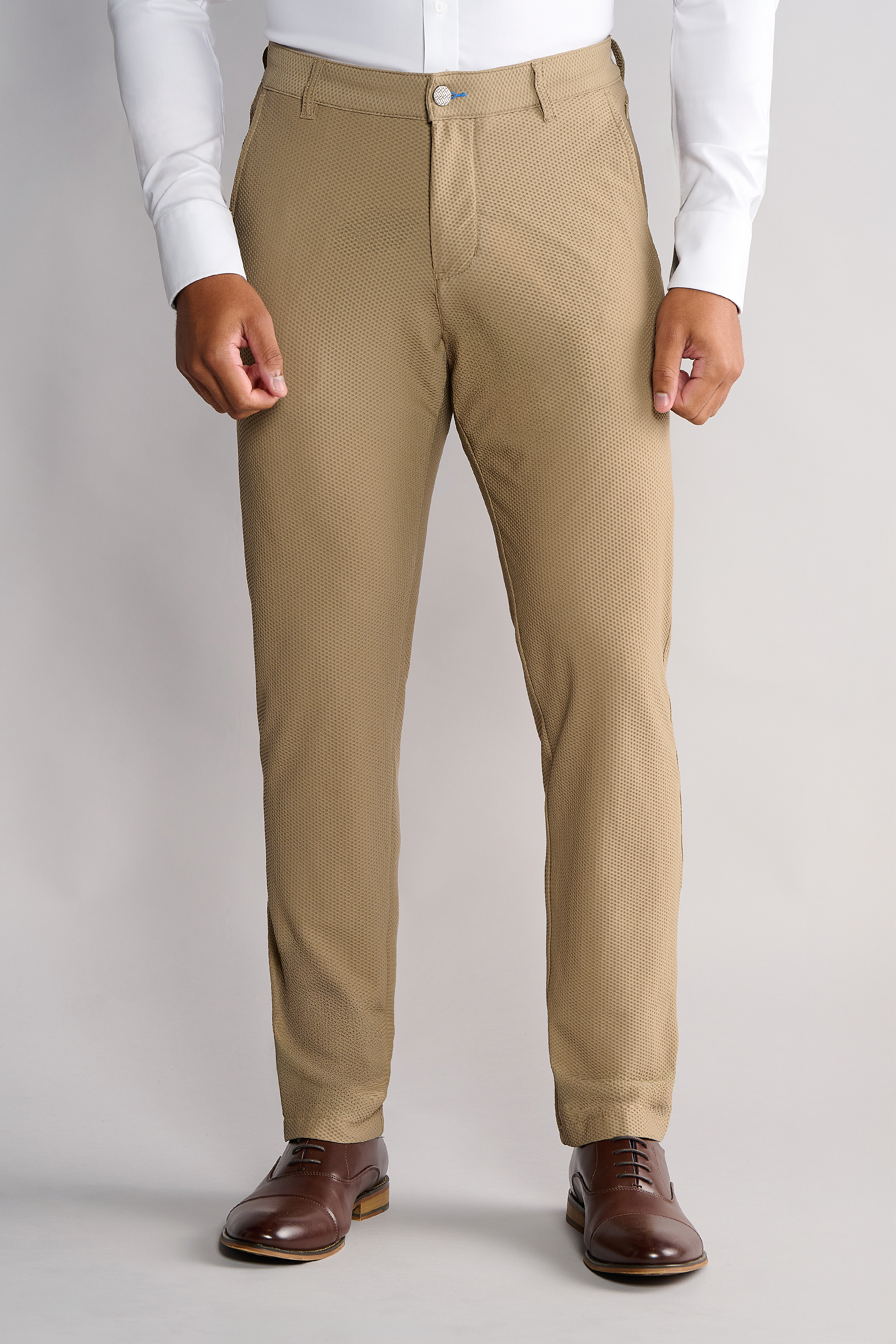 A person stands facing forward, wearing Twillory AIR Pants in Khaki. Only the lower torso, legs, and part of the arms are visible against a plain, light background.