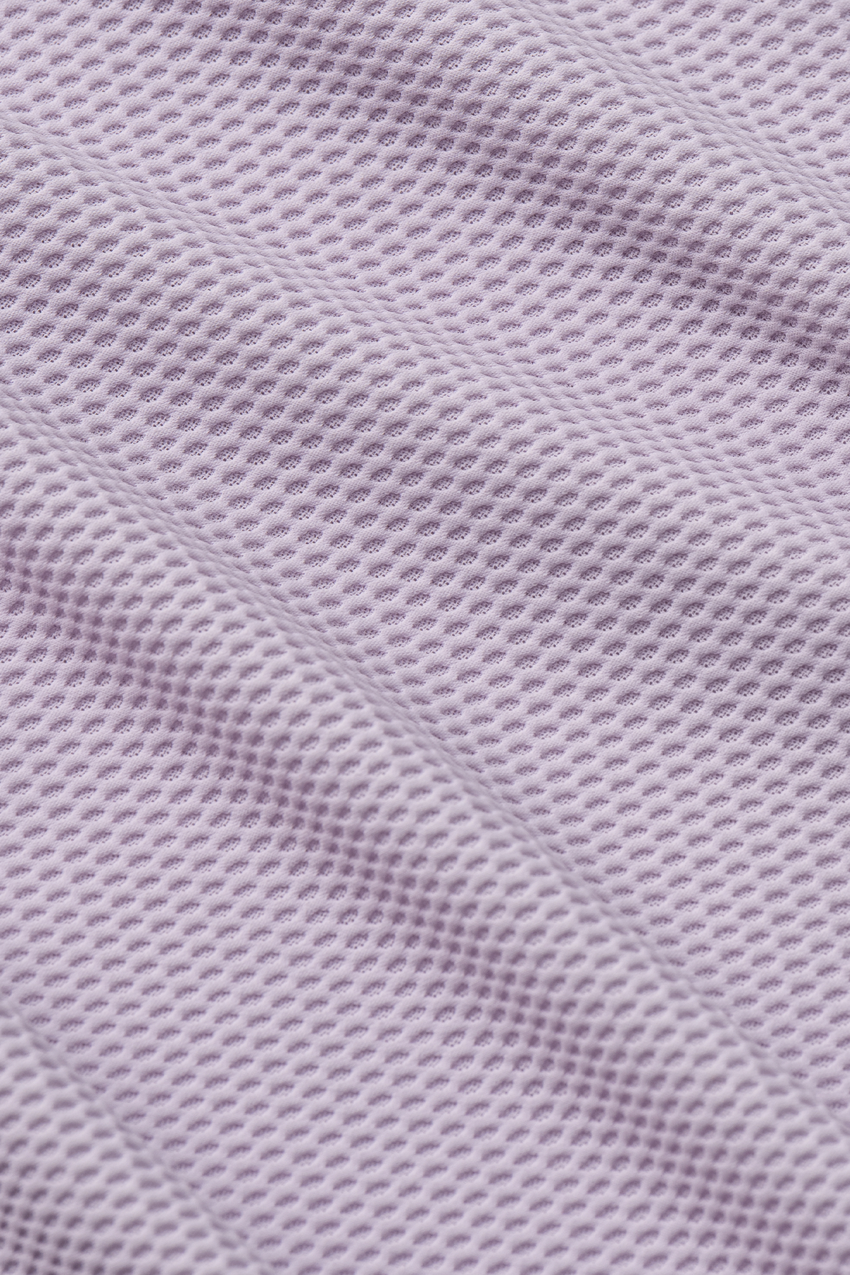 Close-up of the Twillory AIR 3 Button Polo Solid in Lilac, featuring soft 360° Airflow Fabric with small, uniform holes for breathability—ideal for temperature regulation and wrinkle resistance.