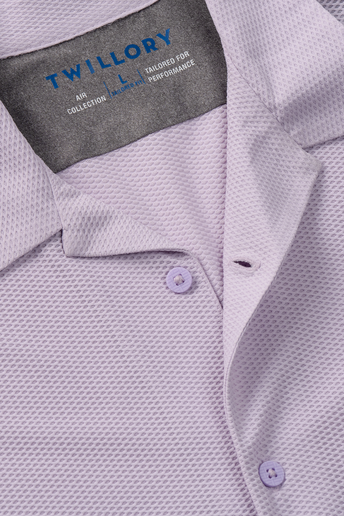 Close-up of the Twillory AIR Resort Shirt Solid in Lilac—a light lavender collared shirt with a textured pattern, made from breathable AIR fabric. Features light purple buttons and neat stitching; part of Twillory’s Air Collection.