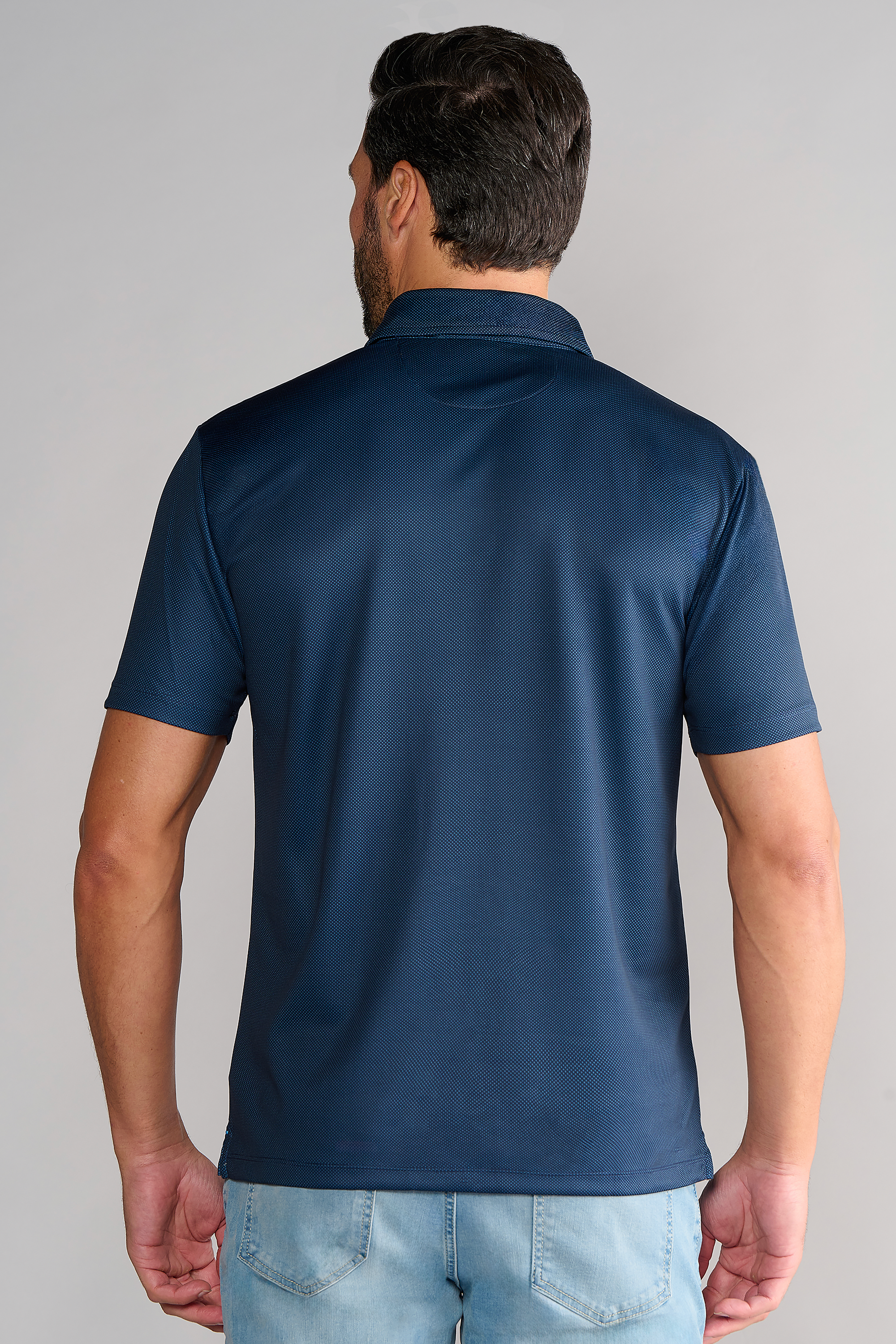A man in a navy Twillory Short Sleeve Polo Dot.