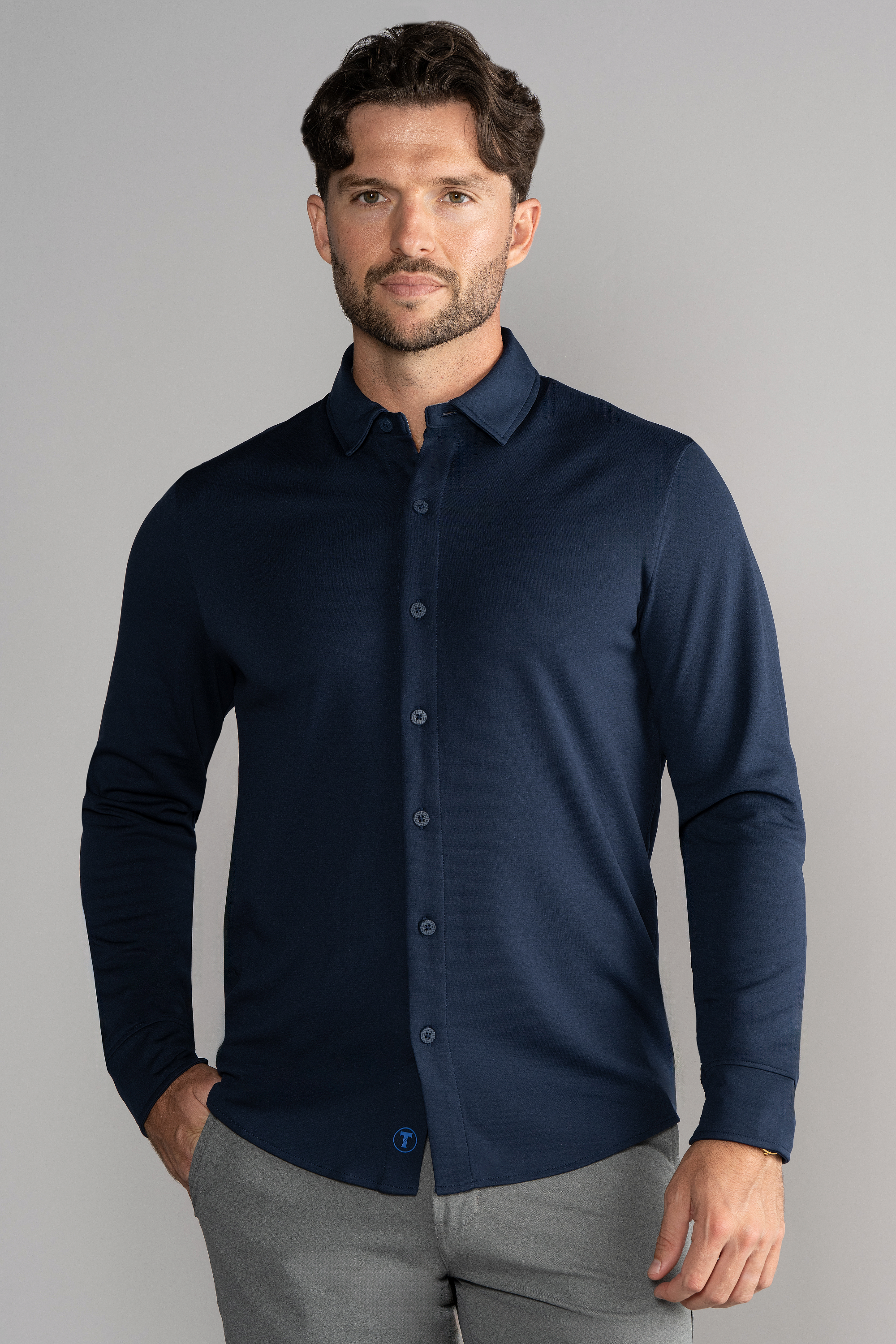 A man in a Twillory Long Sleeve Button Down Polo Solid shirt in navy.
