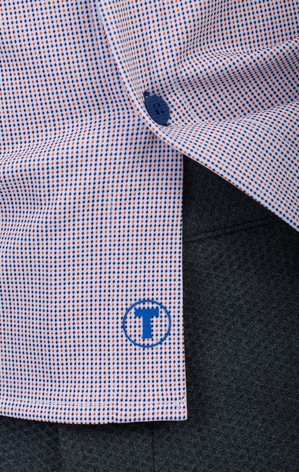 A close-up of the Twillory Long Sleeve Button Down Polo Dot in Orange Blue.