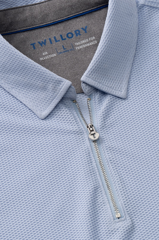 Close-up of the Twillory AIR Zip Polo Solid in Powder Blue, featuring 360° Airflow Fabric, a silver zipper, structured collar, and subtle waffle texture for breathable all-day comfort.