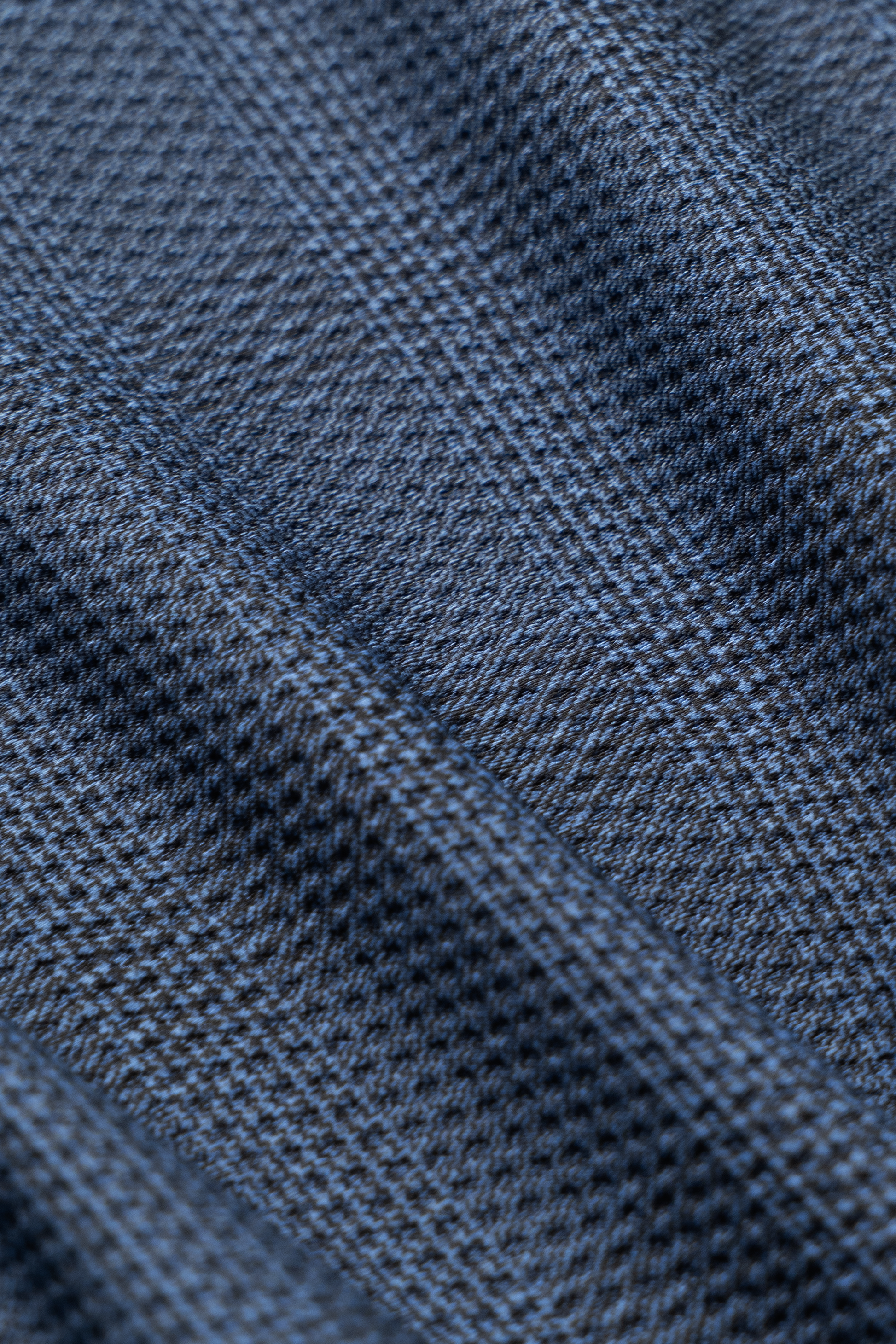 Close-up of Twillory AIR Shorts' textured fabric, featuring blue and gray diagonal stripes. The subtle plaid weave is soft, slightly raised, and sweat-wicking—perfect for these 4-way stretch shorts.