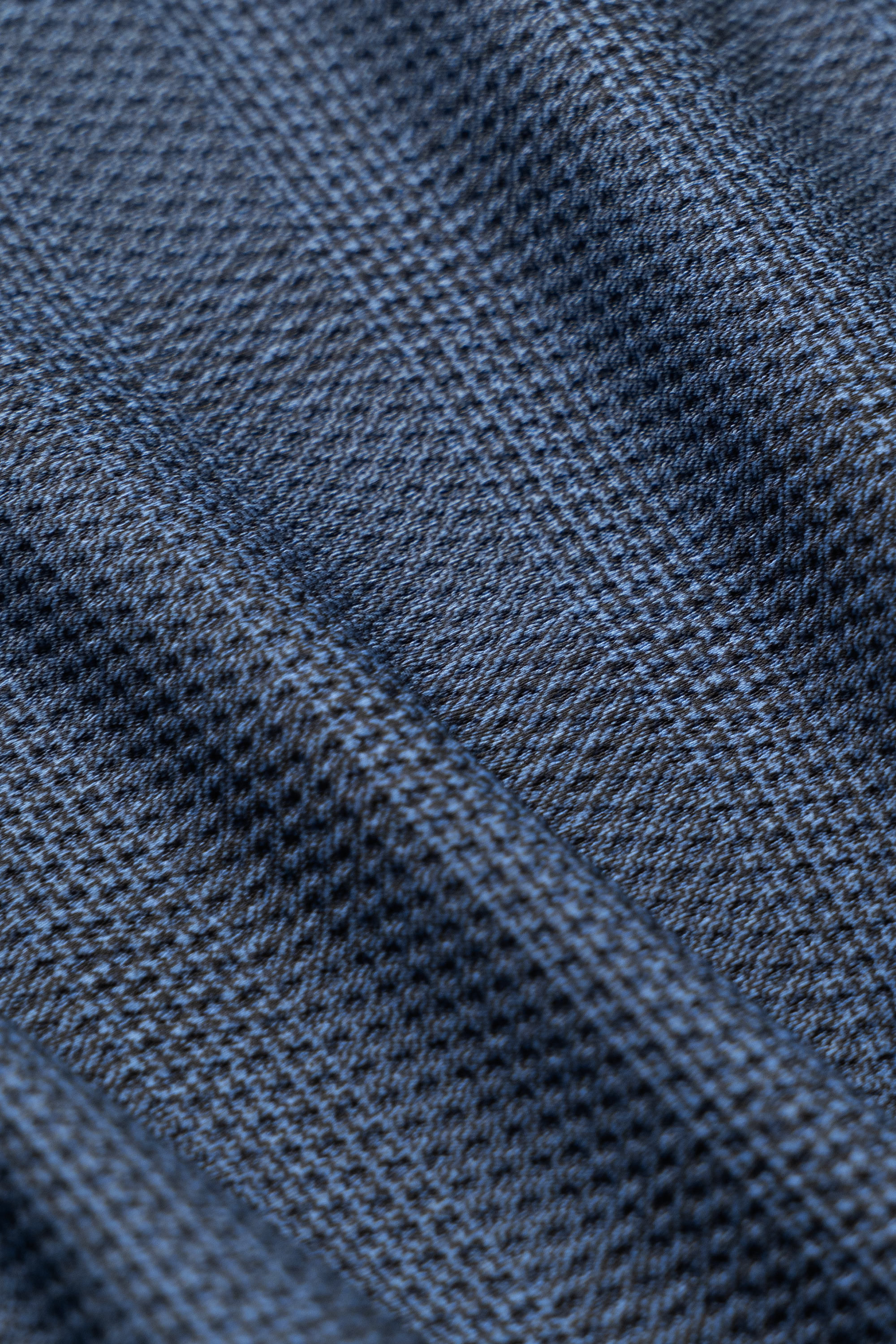 Close-up of Twillory AIR Shorts' textured fabric, featuring blue and gray diagonal stripes. The subtle plaid weave is soft, slightly raised, and sweat-wicking—perfect for these 4-way stretch shorts.