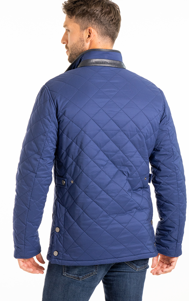 Man wearing a blue quilted jacket and jeans, shown from the back.