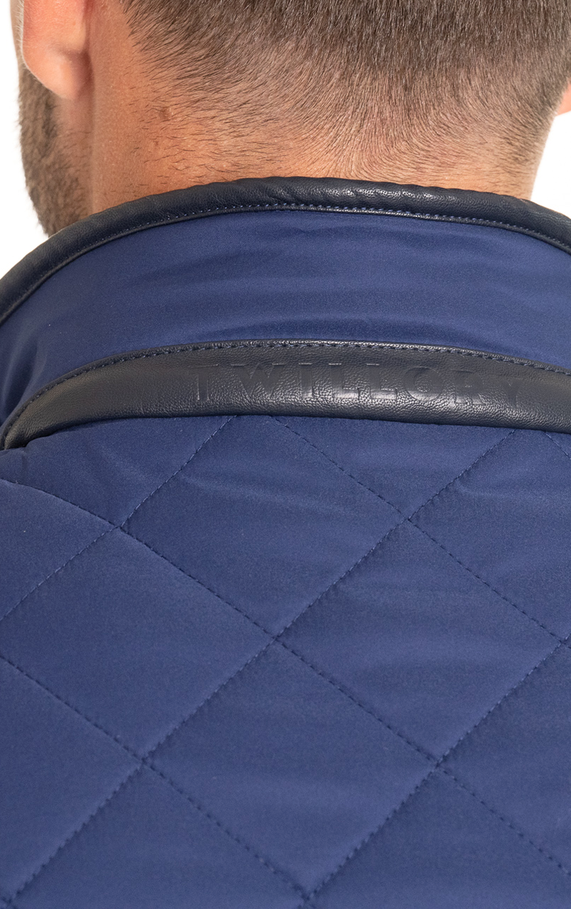 Close-up of a man's neck wearing a blue quilted jacket with a leather-trimmed collar.