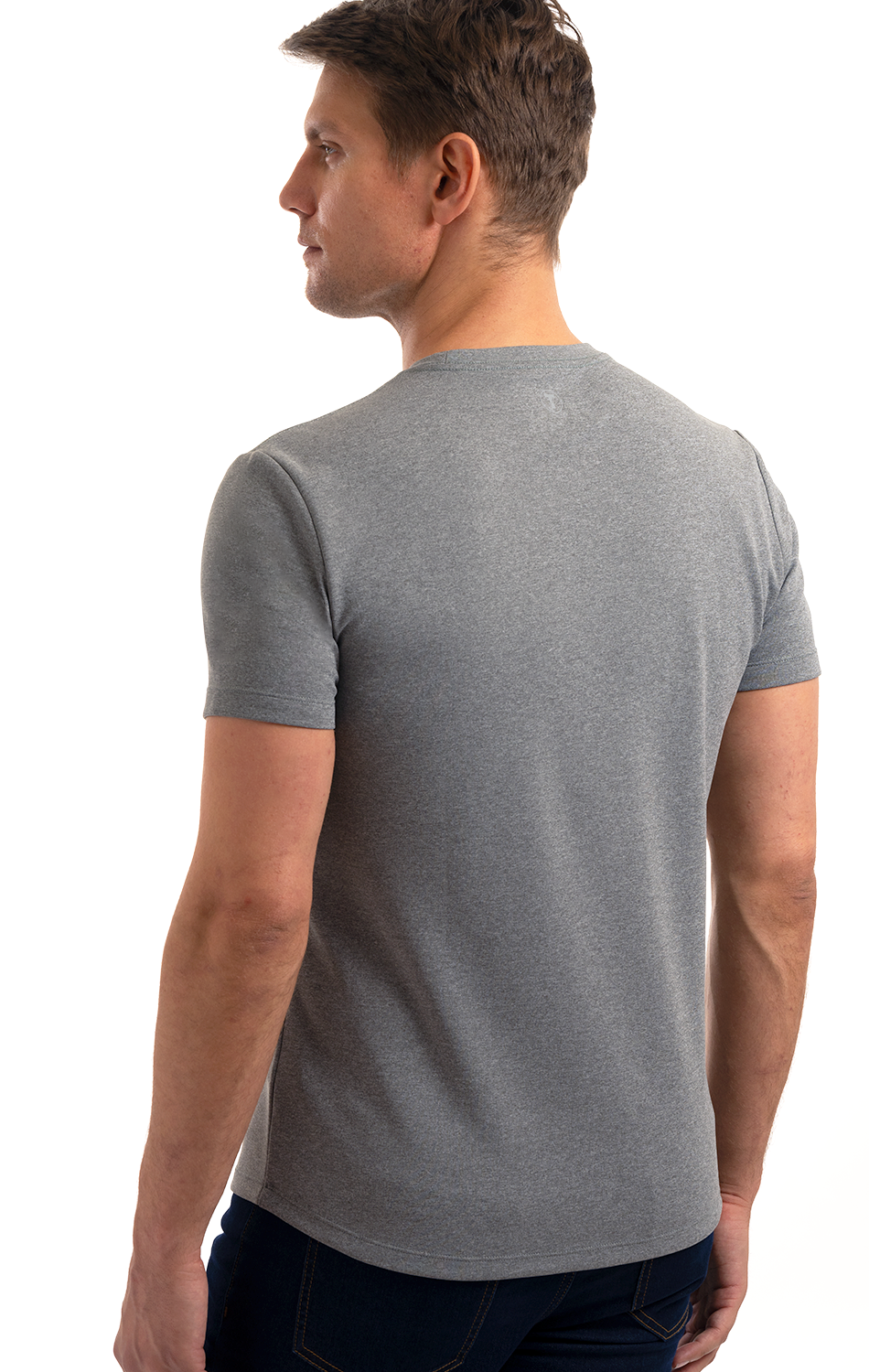 Man in gray t-shirt viewed from the back standing against a white background.